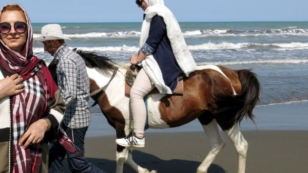 An Iranian woman rides a horse by the Caspian Sea coast in the port city of Gisum, in the northern province of Gilan on August 23, 2017. (AFP)