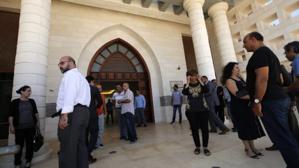 People gather at the presidential palace near the city of Ramallah in the occupied West Bank after Palestinian officials announced a project to transform the building into a national library. President Mahmud Abbas and his cash-strapped administration had faced questions over the construction of the $17.5 million palace, which was initially intended as a presidential headquarters and location where foreign dignitaries could be received. (AFP)