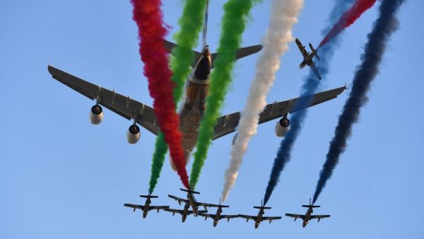 Aermacchi MB-339 jets from UAE's Al-Fursan display team perform with an Etihad Airways' Airbus A380 before the start of the Abu Dhabi Formula One Grand Prix at the Yas Marina circuit on Nov. 26, 2017. 

(Andrej ISAKOVIC / AFP)