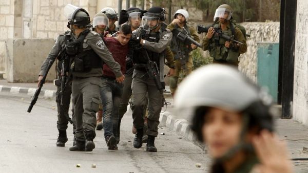 Israeli security forces detain a Palestinian protester during clashes at the main entrance of the Israeli occupied West Bank city of Bethlehem on Dec. 22, 2017 (Musa AL SHAER / AFP)