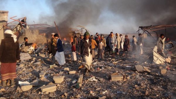 Smoke rises as Yemenis inspect the damage at the site of air strikes in the northwestern Huthi-held city of Saada, on Jan. 6, 2018 (STRINGER / AFP)