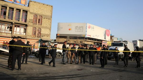 Iraqi security forces cordon off the area where a double suicide bombing killed more than 20 people in central Baghdad on Jan. 15, 2018, the second such attack in the Iraqi capital in three days (SABAH ARAR / AFP)


