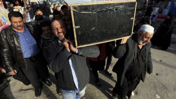 Iraqis carry the coffin of a victim during a funeral in the holy city of Najaf, on January 15, 2018, following today's twin suicide bombing in the capital Baghdad. Iraq's Prime Minister Haider al-Abadi called for the elimination of jihadist "sleeper cells" after the bombing killed 31 people in Baghdad in the second such attack in three days.
