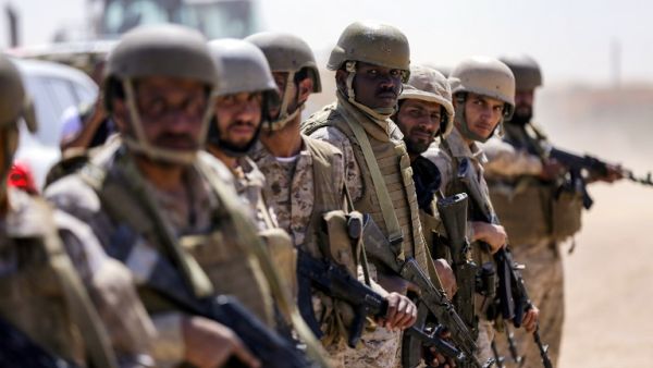 Saudi soldiers stand by in an airfield as a Saudi Air Force cargo plane lands at an airfield in Yemen's northeastern province of Marib on Jan. 26, 2018 (ABDULLAH AL-QADRY / AFP)