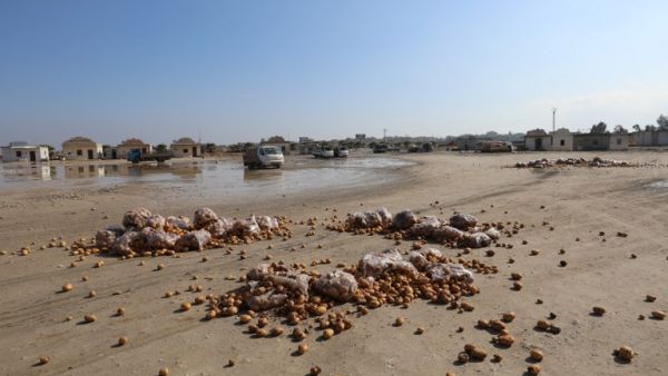 A picture taken on Jan. 29, 2018 shows potatoes strewn on the ground in the vegetable market of the town of Saraqeb in Syria's northwestern province of Idlib, following airstrikes by regime forces (OMAR HAJ KADOUR / AFP)