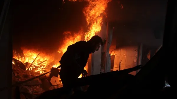 A Syrian man searches for people in a fire following regime air strikes on the rebel-held besieged town of Douma in the eastern Ghouta region, on the outskirts of the capital Damascus, on Feb. 7, 2018. 
(Hamza Al-Ajweh / AFP)