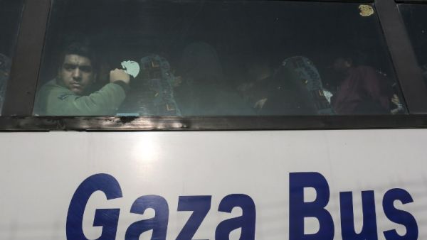 A Palestinian looks out of the window of a bus as travelers arrive at the Rafah border crossing in the southern Gaza Strip to cross into Egypt, after it was opened by Egyptian authorities for humanitarian cases on Feb. 7, 2018.
(SAID KHATIB / AFP)