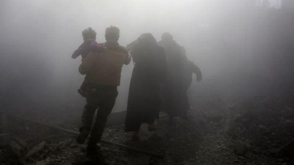 A Syrian family walks through a dust cloud while fleeing from reported regime air strikes in the rebel-held town of Jisreen, in the besieged Eastern Ghouta region on the outskirts of the capital Damascus, on Feb. 8, 2018. A fourth consecutive day of heavy regime bombing raids on the rebel-held enclave of Eastern Ghouta near Damascus killed 22 civilians on Feb. 8, a monitor said.
(ABDULMONAM EASSA / AFP)