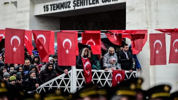 People stand by Turkish flags as they attend a funeral ceremony for Koray Karaca, a Turkish soldier who was killed in cross-border clashes with Kurdish People's Protection Units (YPG) forces in Afrin, Syria, in Istanbul on Feb. 11, 2018. On Jan. 20, Turkey launched a military operation against the Kurdish People's Protection Units (YPG) militia in the Afrin region, backing Syrian rebels with air strikes and ground troops.
(YASIN AKGUL / AFP)