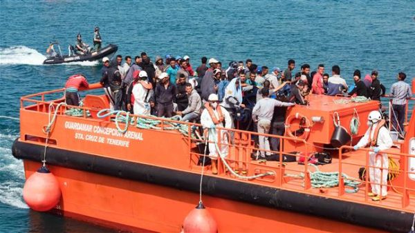 Would-be immigrants stand on the Salvamar Guardamar C. Arenal vessel as they arrive in the port of Tarifa following their rescue by salvage vessels off the Strait of Gibraltar coast, on June 23, 2017 (AFP/File)