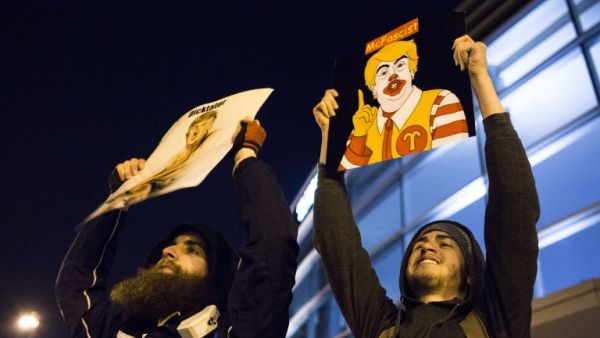 Protesters celebrate outside of the University of Illinois at Chicago Pavilion where Republican presidential candidate Donald Trump cancelled a campaign rally over safety concerns March 11, 2016 in Chicago, Illinois. (AFP/Jonathan Gibby)