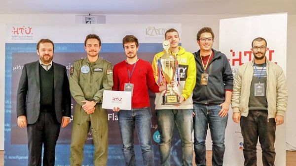 Crown Prince Hussein poses for a photo with the winners of Al Hussein Technical University cybersecurity Hackathon competition, on Wednesday (Petra Photo)