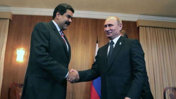 Venezuelan President Nicolas Maduro and his Russian counterpart Vladimir Putin shake hands in this 2015 photo. (AFP)