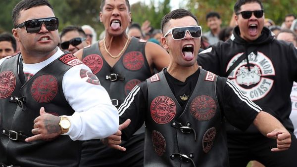 A notorious motorcycle gang (pictured performing a haka at the Jamia Masjid mosque in Hamilton on the North Island) stood guard outside the mosque on Friday in a moving display of solidarity after the Christchurch terror attack (AFP)