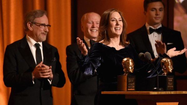 Kathleen Kennedy and Frank Marshall accept the Irving G. Thalberg Memorial Award from Steven Spielberg onstage during the Academy of Motion Picture Arts and Sciences’ 10th annual Governors Awards. (Source: AFP)