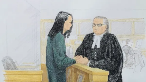 In this courtroom sketch by Jane Wolsak and released to AFP by the artist, Meng Wanzhou (L), Huawei's chief financial officer, speaks with lawyer David Martin in the courtroom in Vancouver. (AFP/ File)