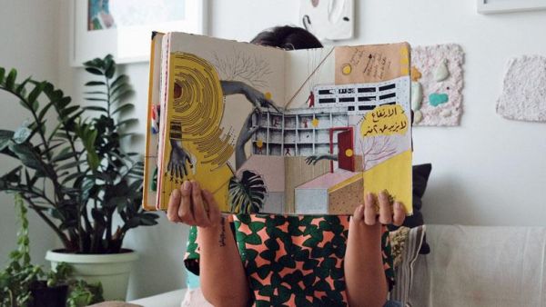 Nahla Tabbaa holds Daftar Asfar. The first edition, along with other editions of the sketchbook, will go on display in Dubai, on Wednesday (Photo courtesy of Nahla Tabbaa)