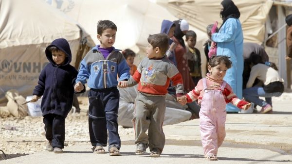 Syrian children walk amid tents at the Zaatari refugee camp, near the Syrian border with Jordan in Mafraq. (AFP)