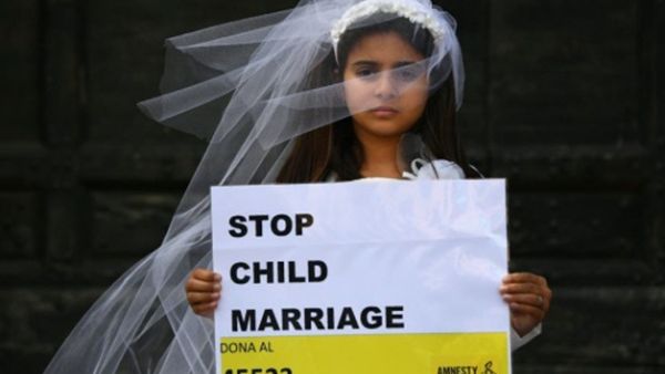 A young actress plays the role of a child bride during a protest organised by Amnesty (AFP/File Photo)	