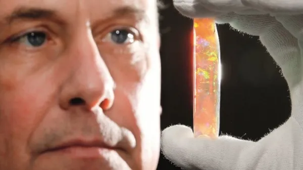 South Australian Museum Director Brian Oldman with the Virgin Rainbow opal — one of the highlights of the exhibition. (Peninsula)