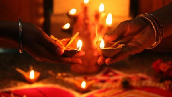 Devotees hold oil lamps as they celebrate Diwali in Allahabad on November (Sanjay Kanojia/AFP/Getty Images)