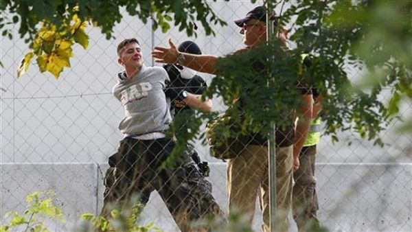 Hungarian police arrest a refugee on the border during clashes last year. (AFP/File)