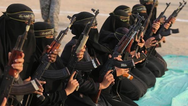 The women of the al-Quds Brigades holding Kalashnikov rifles and poised for action during the exercise at Khan Yunis on the southern section of the Gaza Strip (Shutterstock)