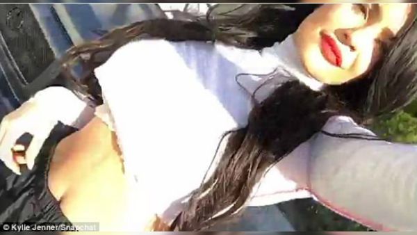 Dressed in a cropped white top and black nylon track pants with an elastic waist, the Keeping Up with the Kardashians star painted her lips a variety of colors (Source: Kylie Jenner - Snapchat)