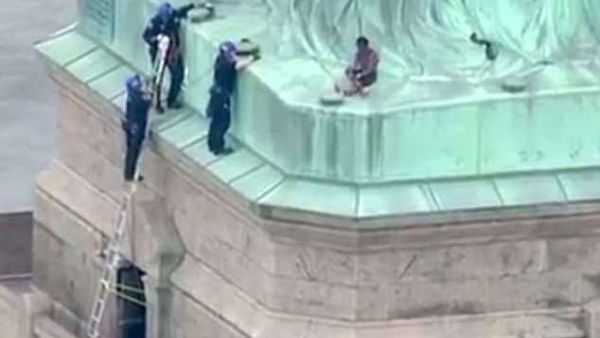 Police were seen talking to Okoumou in an effort to get her down, but she refused to cooperate (AFP/File Photo)
