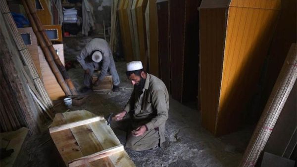 A carpenter builds a coffin in his workshop (AFP/File Photo)