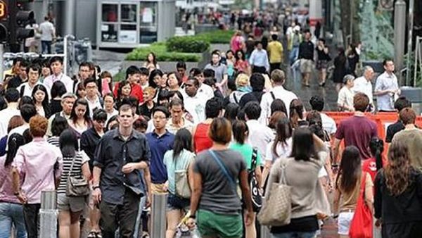People walking along Orchard Road in Singapore (AFP/File Photo)