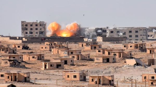 Smoke rises from buildings in the area of Bughayliyah, on the northern outskirts of Deir Ezzor city. (AFP/ George OURFALIAN)
