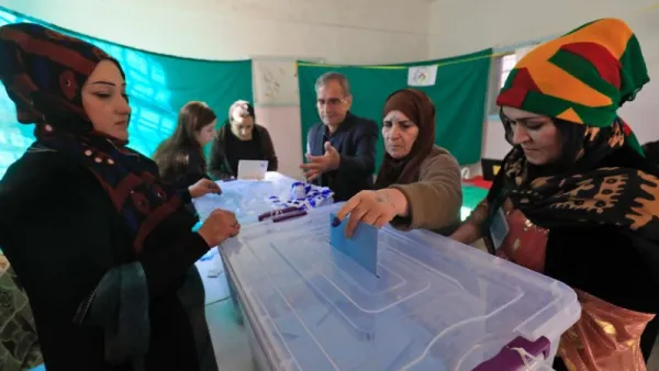 A Syrian woman casts her vote in local elections held in the Kurdish-dominated northern city of Qamishli (AFP/Delil souleiman)