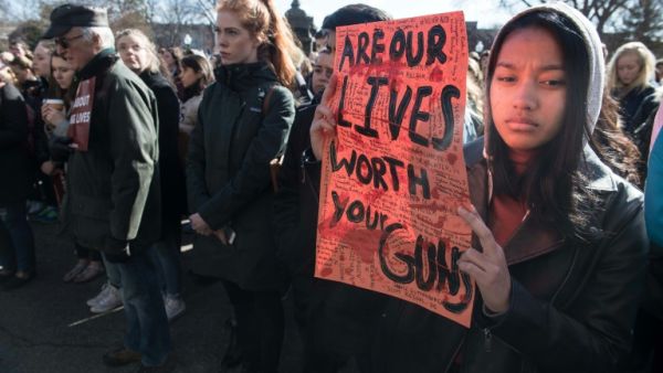  A student holds a sign during the protest against gun violence (AFP/File Photo)