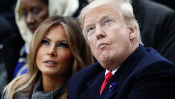 US First Lady Melania Trump (L) and US President Donald Trump (R) look on as they attend a ceremony at the Arc de Triomphe in Paris on November 11, 2018 as part of commemorations marking the 100th anniversary of the 11 November 1918 armistice, ending World War I. 
Francois Mori / POOL / AFP