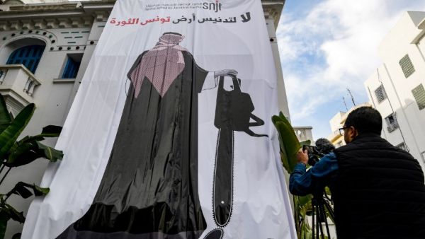 This picture taken on November 26, 2018 shows a giant banner hanging at the headquarters of Tunisia's Journalists Union in the capital Tunis depicting a cartoon of Saudi Crown Prince Mohammed bin Salman (AFP)