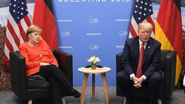 Angela Merkel looks less than impressed with Donald Trump during a meeting at the G20 Summit in Buenos Aires (AFP)