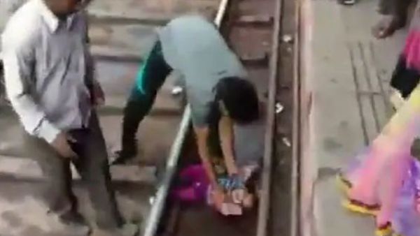 The girl is seen crying on the tracks at a railway station at Mathura after getting stuck in between the tracks (Twitter)