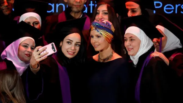 Syria's First Lady Asma al-Assad (centre) poses for a picture during a graduation ceremony of future teachers of a Syrian Organisation for Persons with Disabilities, in Damascus yesterday (Twitter)