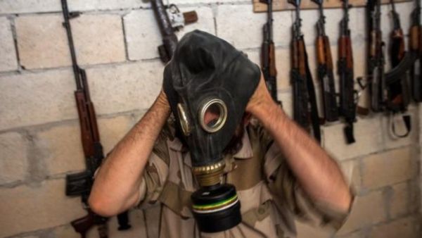 A Syrian rebel tries on a gas mask in the northwestern province of Idlib, on July 18, 2013. (AFP/File)