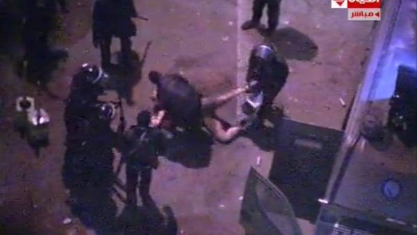 An image grab taken from Al-Hayat TV purportedly shows Egyptian riot police dragging and beating an unidentified semi-naked man during clashes with anti-president protestors outside the Presidential Palace. (AFP PHOTO/Al-Hayat TV)