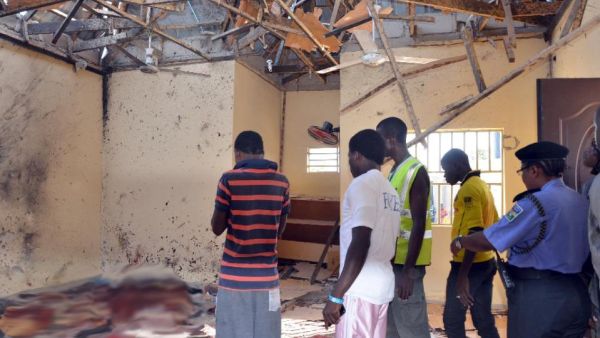 People standing in a mosque following a suicide bombing in northeast Nigeria. (AFP Photo/Stringer)

