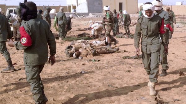 Soldiers attend to wounded and casualties in the aftermath of a suicide bomb attack who ripped through a camp grouping former rebels and pro-government militia in troubled northern Mali left 40 people dead on January 18, 2017 in Gao. (AFP/Stringer)