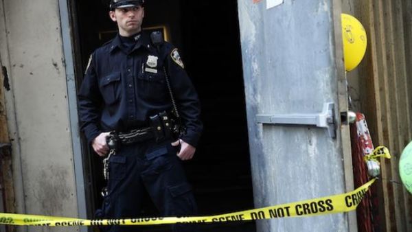 A NYPD officer stands in front of the New York building where a piece of airplane, believed to belong to one of those hijacked on 9/11, was found twelve years on. AFP photo