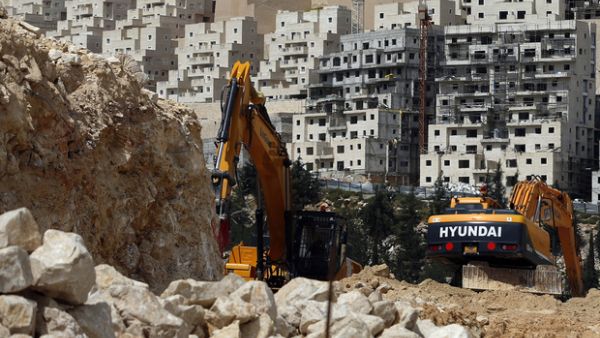 Israeli construction cranes and excavators at a building site of new housing units in the Jewish settlement of Neve Yaakov (AFP)
