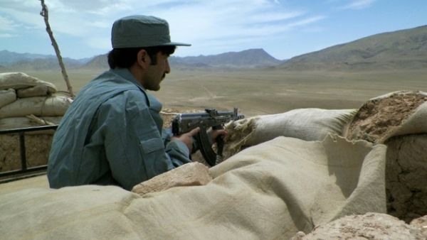 An Afghan policeman observes the Tarin Kot highway in central Afghanistan. (AFP/File)
