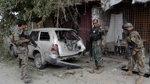 Afghan soldiers inspect a destroyed vehicle after an operation to capture Islamic State fighters in Kot District in eastern Nangarhar province on July 26, 2016. (AFP/Noorullah Shirzada)