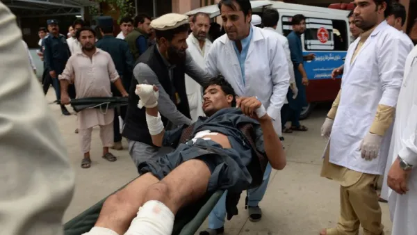 Afghan volunteers carry an injured youth on a stretcher to a hospital, following an attack that targeted a parliamentary election rally in the Kama district of the eastern province of Nangarhar, in Jalalabad on October 2, 2018. (NOORULLAH SHIRZADA / AFP)
