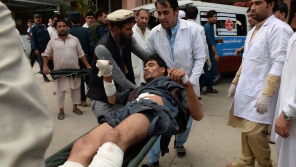 Afghan volunteers carry an injured youth on a stretcher to a hospital, following an attack that targeted a parliamentary election rally in the Kama district of the eastern province of Nangarhar, in Jalalabad on October 2, 2018. (NOORULLAH SHIRZADA / AFP)
