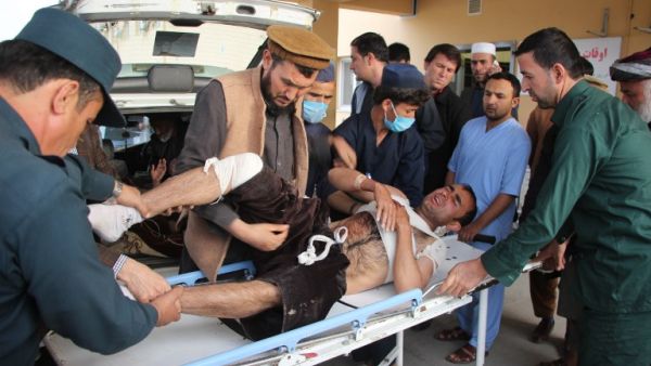 Afghan volunteers transport an injured man on a stretcher to a hospital following a bomb attack in Taloqan in northeastern Takhar province on October 13, 2018. (NASEER SADEQ / AFP)